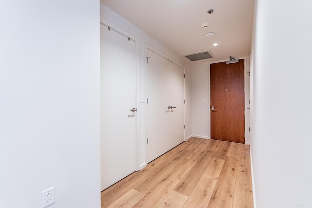 hall with light hardwood / wood-style floors