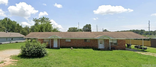 ranch-style home featuring a front yard