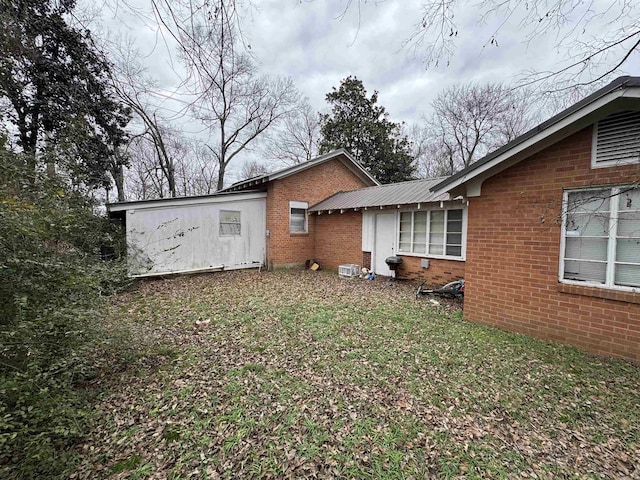 rear view of house with a yard