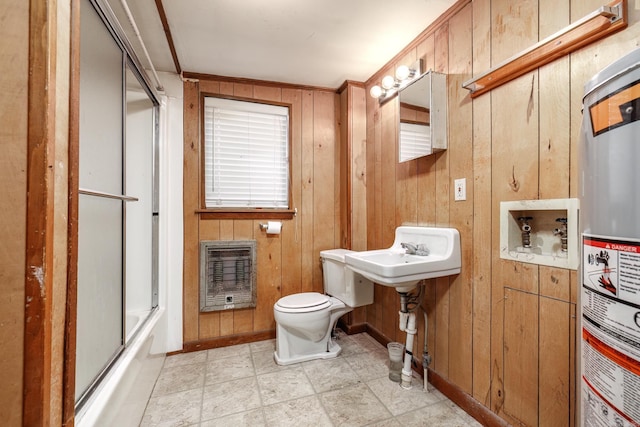 bathroom with water heater, heating unit, wood walls, toilet, and ornamental molding