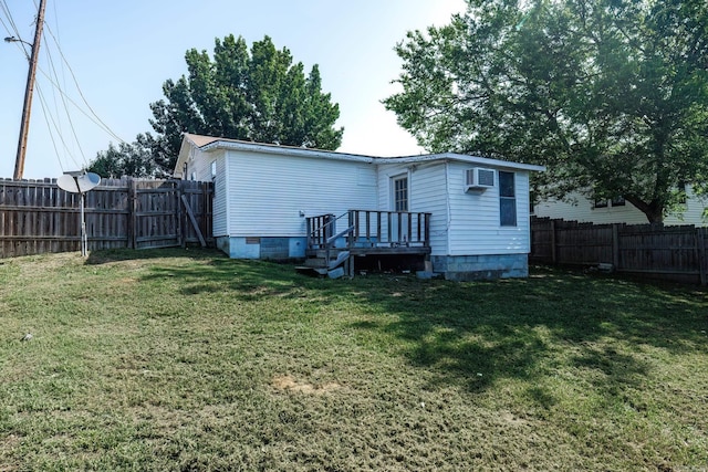 back of property with a lawn and an AC wall unit