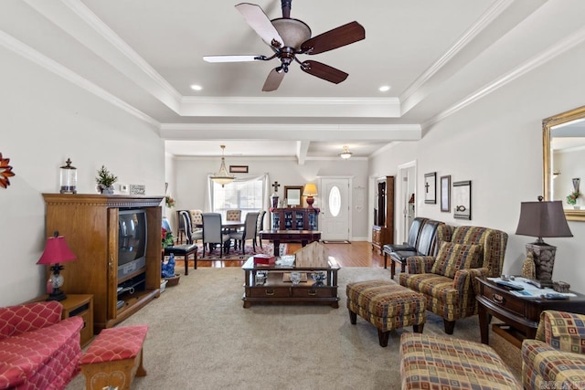 living room with hardwood / wood-style floors, ceiling fan, and ornamental molding