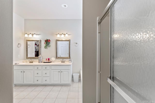 bathroom with tile patterned floors, vanity, and a shower with shower door