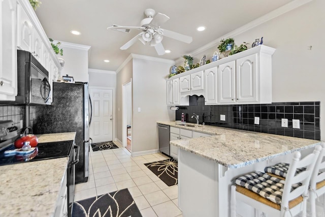 kitchen with appliances with stainless steel finishes, backsplash, ornamental molding, white cabinetry, and light tile patterned flooring