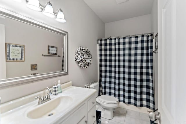 bathroom featuring tile patterned flooring, vanity, and toilet