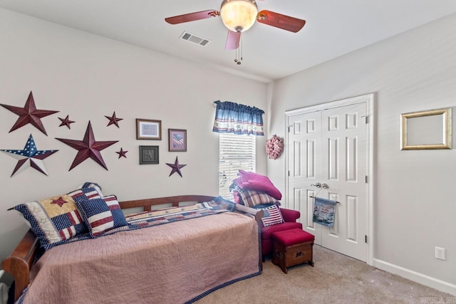 carpeted bedroom with a closet and ceiling fan