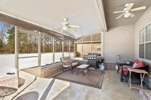 sunroom / solarium with lofted ceiling with beams and ceiling fan