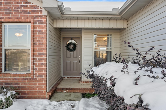 view of snow covered property entrance