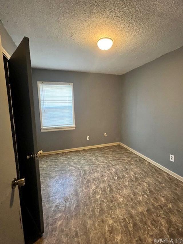 empty room with a textured ceiling