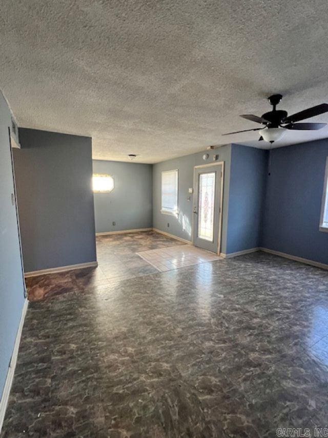 spare room with ceiling fan and a textured ceiling