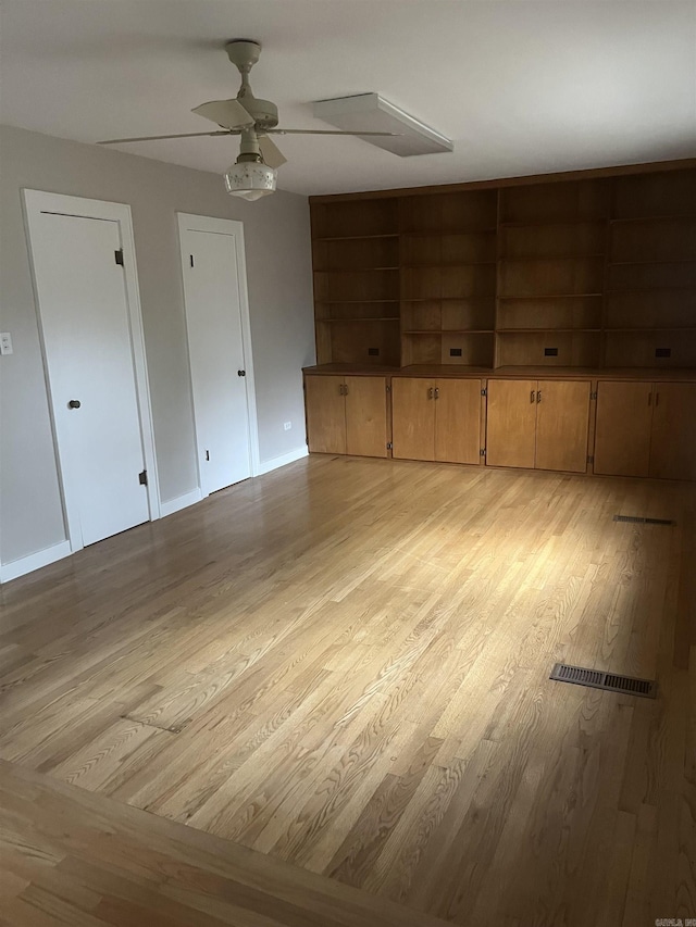 interior space with ceiling fan and light hardwood / wood-style flooring