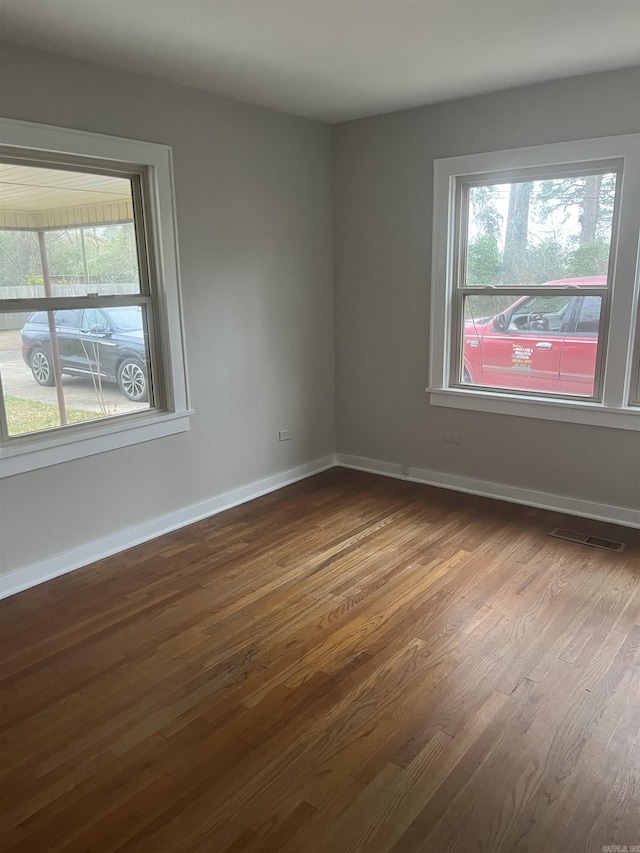 empty room with hardwood / wood-style floors