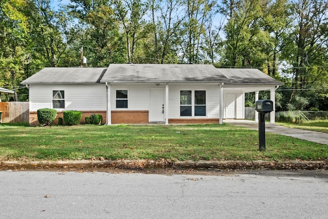 ranch-style home featuring a carport and a front yard