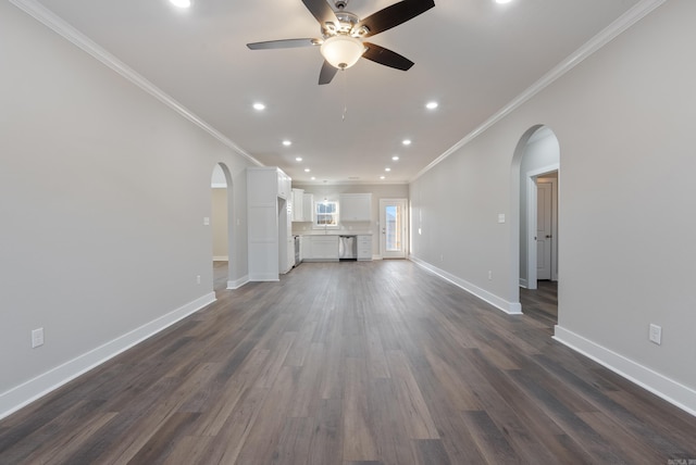 unfurnished living room with dark wood-type flooring, ceiling fan, and crown molding