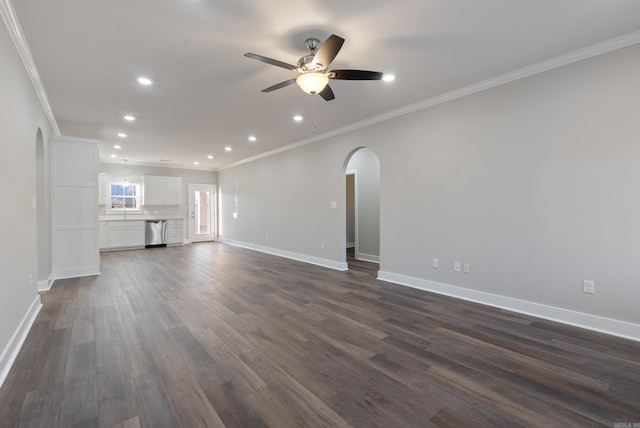 unfurnished living room featuring ceiling fan, dark hardwood / wood-style flooring, ornamental molding, and sink