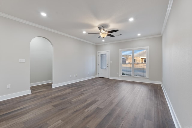 spare room featuring ceiling fan, dark wood-type flooring, and ornamental molding