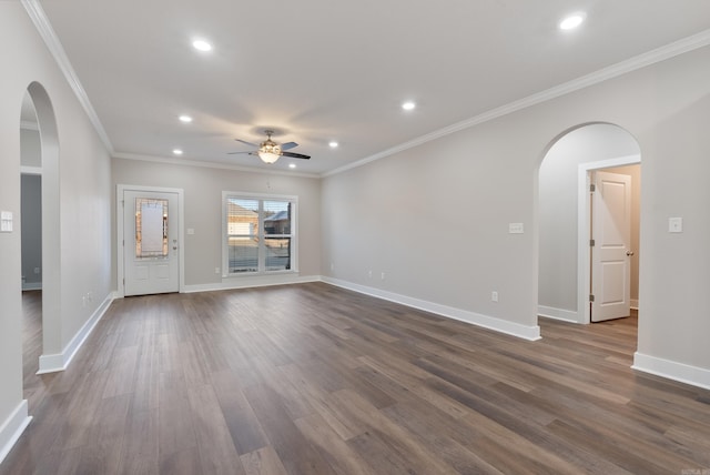 unfurnished living room featuring dark hardwood / wood-style flooring, ceiling fan, and crown molding