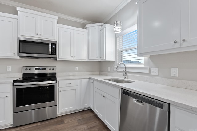 kitchen with sink, crown molding, decorative light fixtures, white cabinets, and appliances with stainless steel finishes