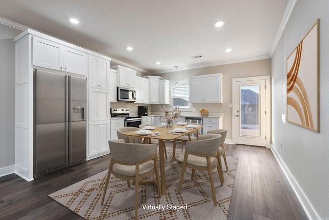 kitchen with white cabinetry, crown molding, stainless steel appliances, and dark hardwood / wood-style floors