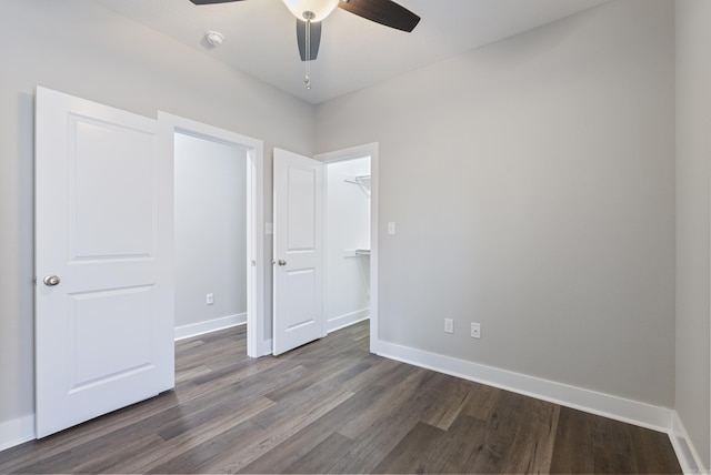 unfurnished bedroom featuring ceiling fan and dark wood-type flooring