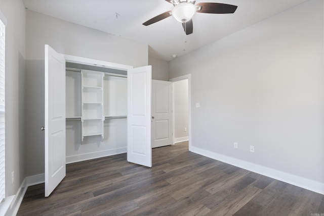 unfurnished bedroom with dark hardwood / wood-style flooring, a closet, and ceiling fan