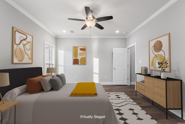 bedroom featuring ceiling fan, dark hardwood / wood-style floors, and crown molding