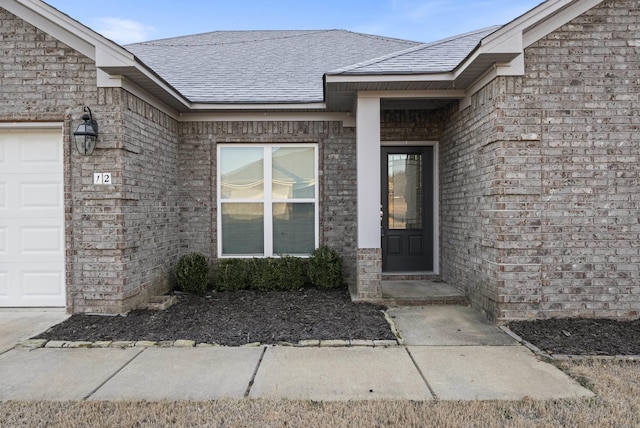 view of exterior entry with a garage