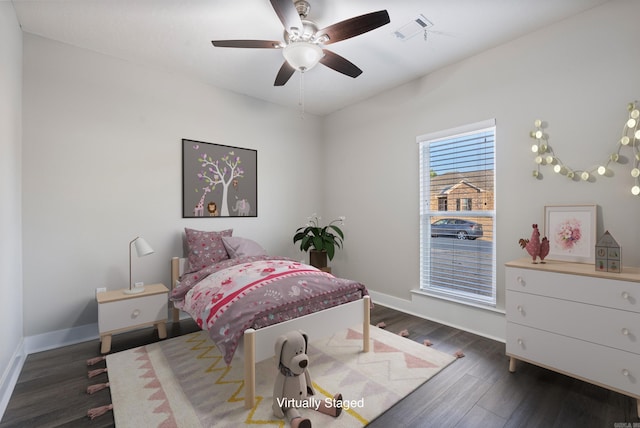 bedroom with dark hardwood / wood-style flooring and ceiling fan