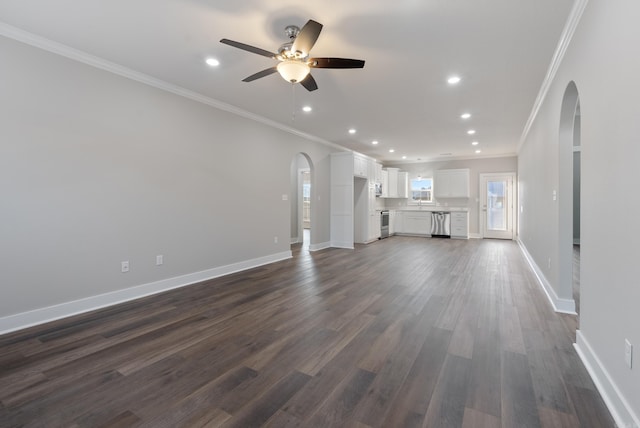 unfurnished living room featuring ceiling fan, ornamental molding, and dark wood-type flooring