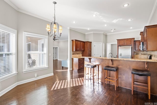 kitchen with decorative backsplash, appliances with stainless steel finishes, dark hardwood / wood-style flooring, and a notable chandelier