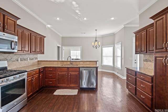 kitchen featuring kitchen peninsula, tasteful backsplash, stainless steel appliances, sink, and a notable chandelier