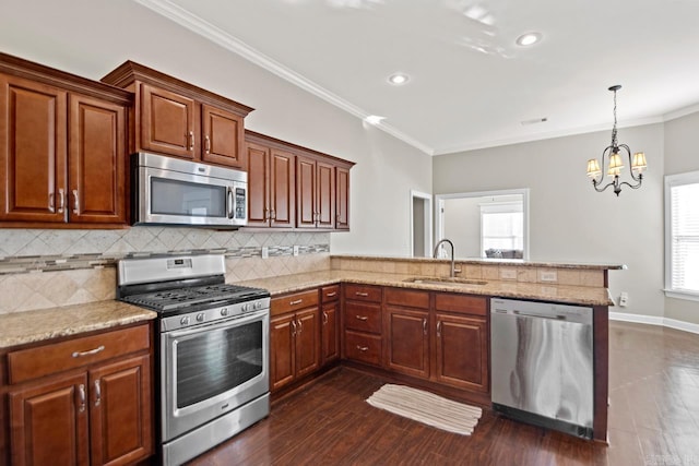 kitchen with crown molding, sink, appliances with stainless steel finishes, tasteful backsplash, and kitchen peninsula