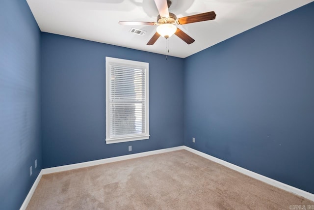 spare room featuring ceiling fan and light carpet