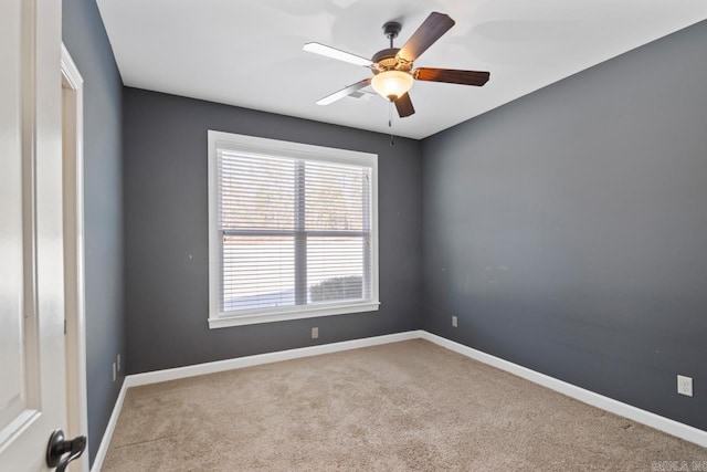 empty room featuring light carpet and ceiling fan