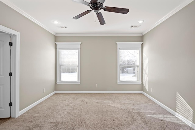 carpeted spare room with ceiling fan and ornamental molding