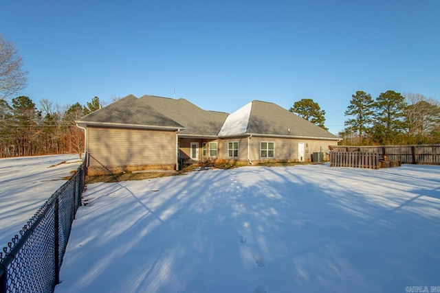 view of snow covered rear of property