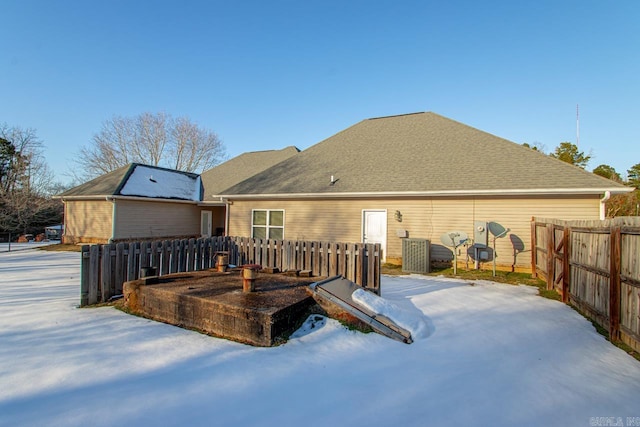 view of snow covered back of property