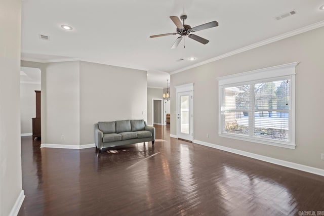 sitting room featuring dark hardwood / wood-style flooring, ceiling fan with notable chandelier, and ornamental molding