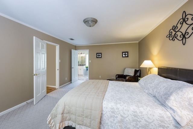 carpeted bedroom featuring ensuite bath and crown molding