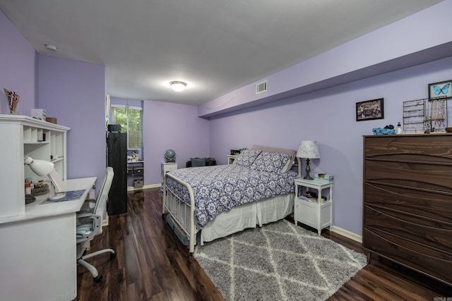 bedroom with dark wood-type flooring