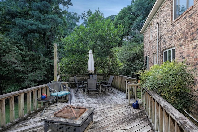 wooden terrace featuring a fire pit