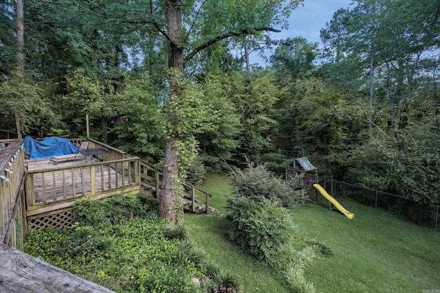 view of yard with a playground and a wooden deck