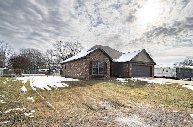 view of front of property with a garage and a front lawn