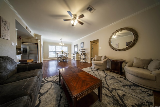 living room with ceiling fan with notable chandelier, crown molding, and dark wood-type flooring