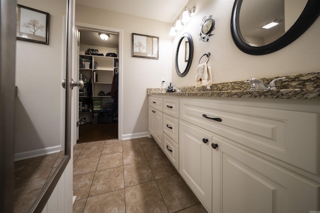 bathroom with tile patterned flooring and vanity