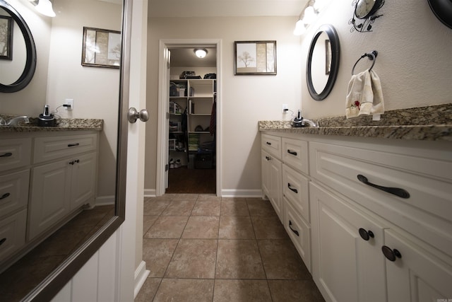 bathroom featuring tile patterned flooring and vanity