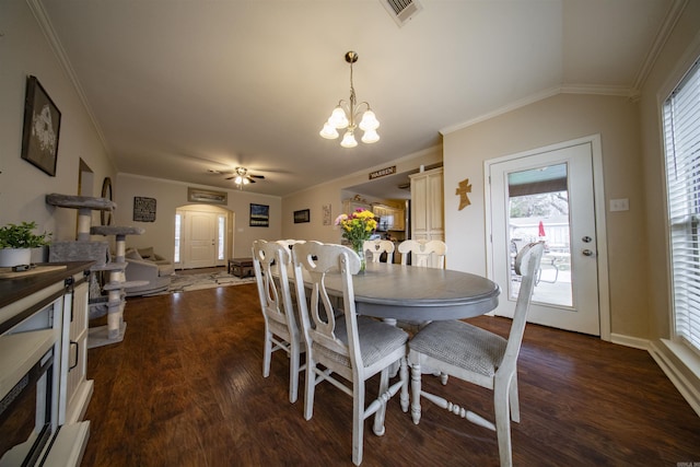 dining area with vaulted ceiling, dark hardwood / wood-style flooring, ceiling fan with notable chandelier, and ornamental molding