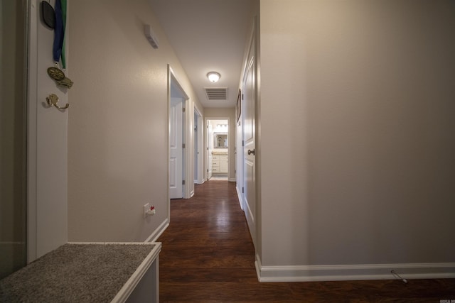 hallway with dark hardwood / wood-style flooring