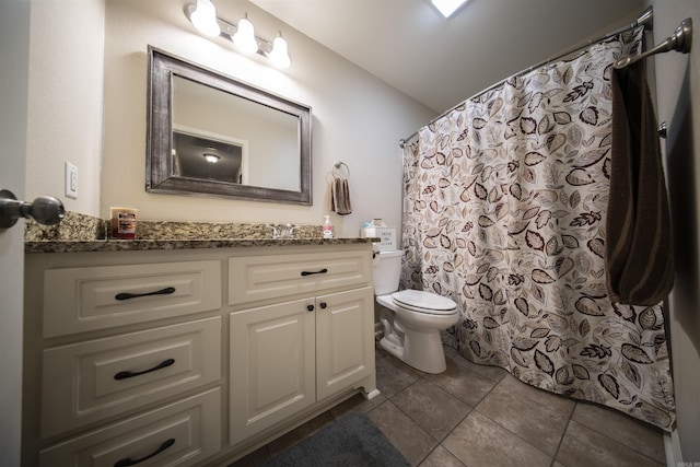 bathroom featuring tile patterned flooring, vanity, and toilet