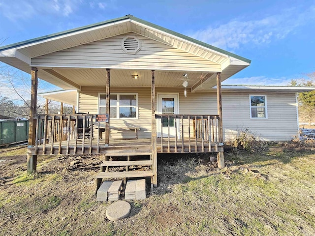 rear view of house featuring a deck